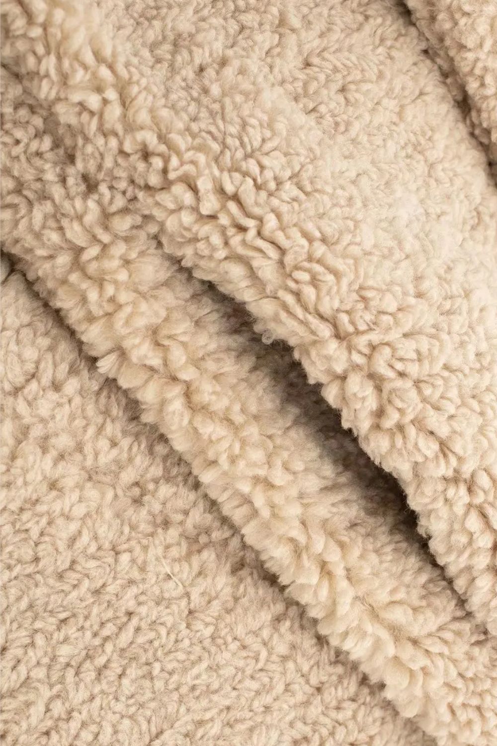 Long women's winter coat made of imitation fur with double-breasted style